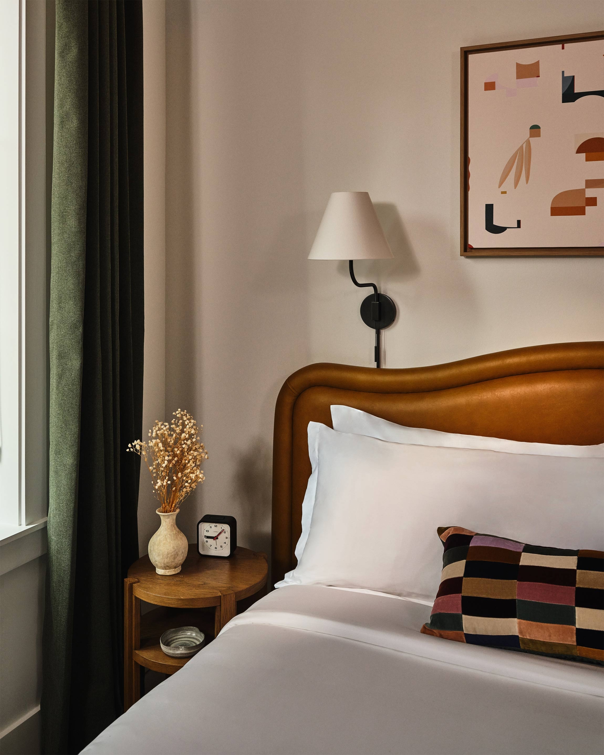 Bed with sidetable and abstract image on the wall